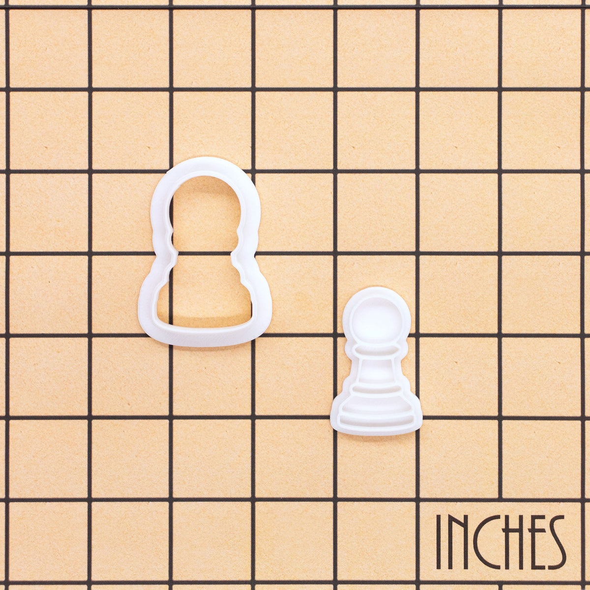 Pawn chess mini cookie cutter and stamp shown on inch grid for size reference