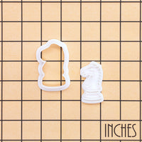 Knight chess mini cookie cutter and stamp shown on inch grid for size reference