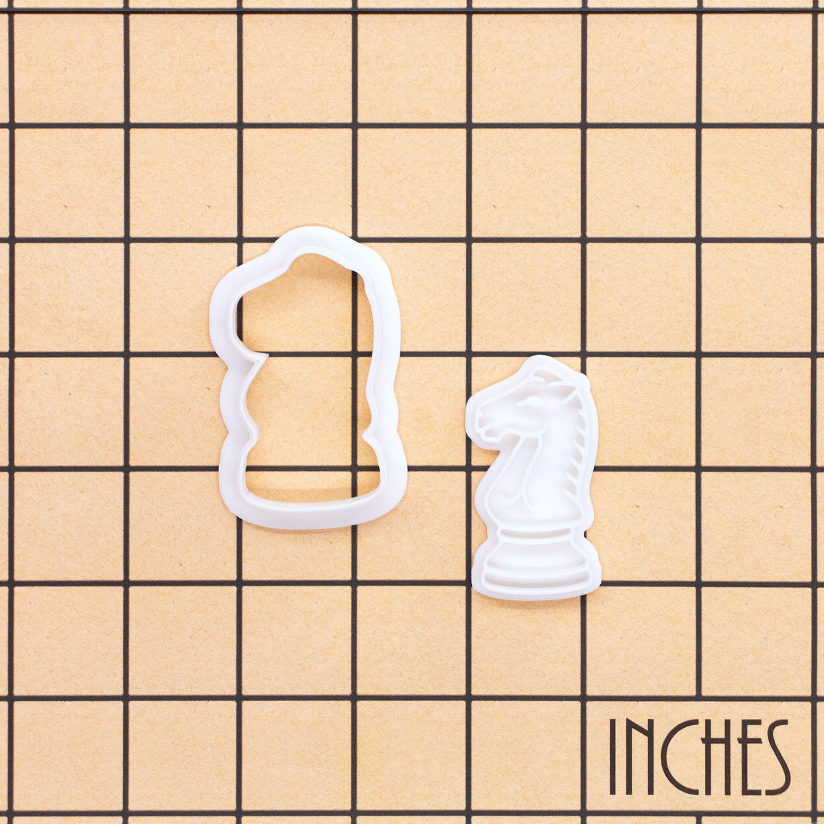 Knight chess mini cookie cutter and stamp shown on inch grid for size reference