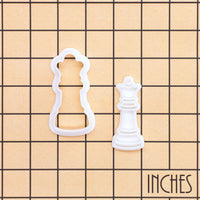 Queen chess mini cookie cutter and stamp shown on inch grid for size reference