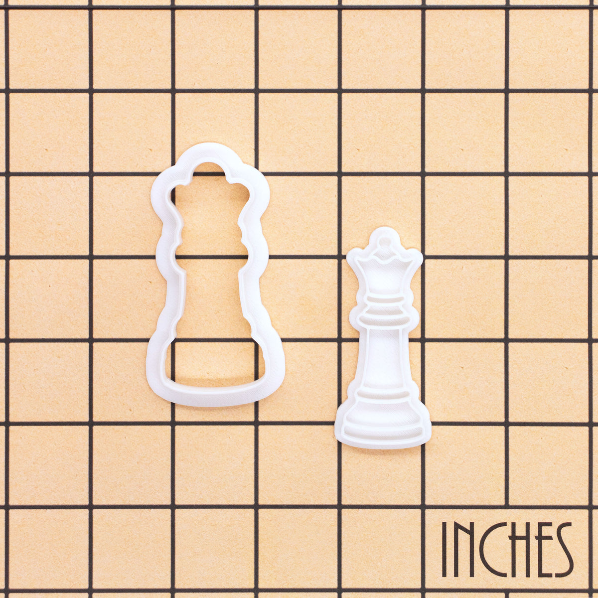 Queen chess mini cookie cutter and stamp shown on inch grid for size reference