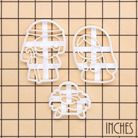 Set of 3 cute Nativity cookie cutters on a size grid in inches, featuring Mary, Joseph and baby Jesus in a manger for Christmas baking