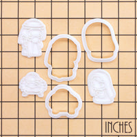 Mary, Joseph and baby Jesus mini cookie cutters and stamps shown on an inch measurement grid