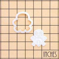 Sheela Na Gig mini cookie cutter and detailed stamp shown on an inch measurement grid