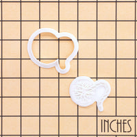 Placenta mini cookie cutter and anatomy detail stamp shown on an inch measurement grid