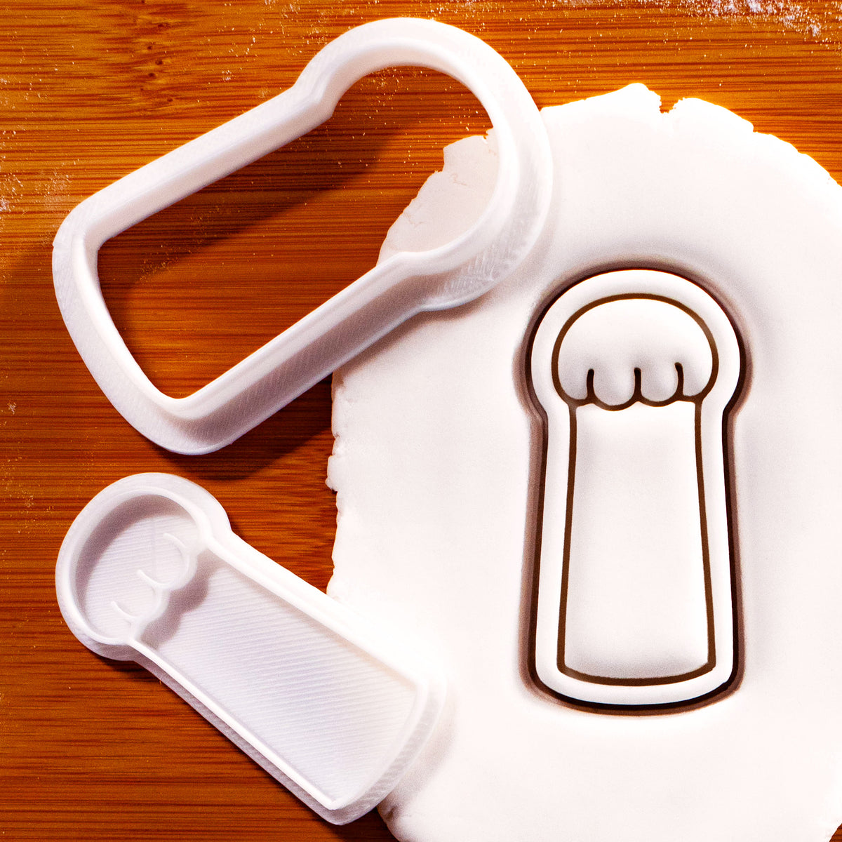 Lucky cat paw mini 2-piece cookie cutter and detail stamp pressed into white fondant