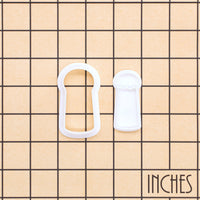 Lucky cat paw mini cookie cutter and stamp shown on an inch measurement grid