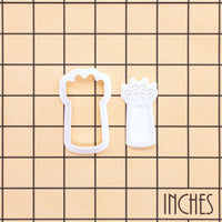 Kitty paw claws mini cookie cutter and separate stamp shown on an inch measurement grid