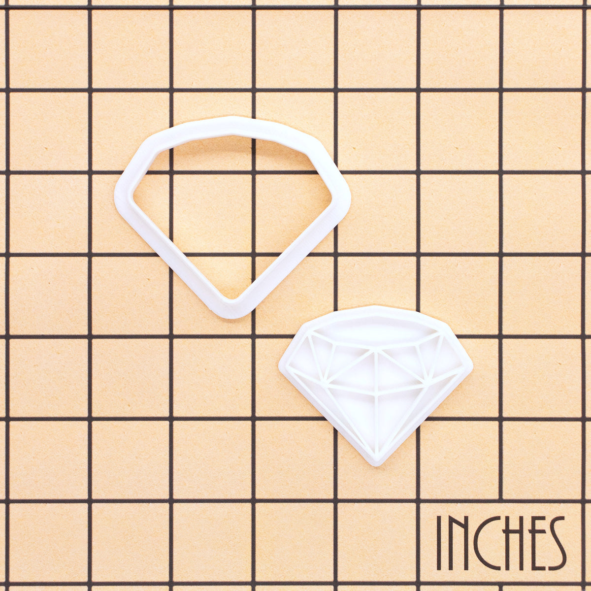 Diamond mini cookie cutter and stamp shown on inch measurement grid