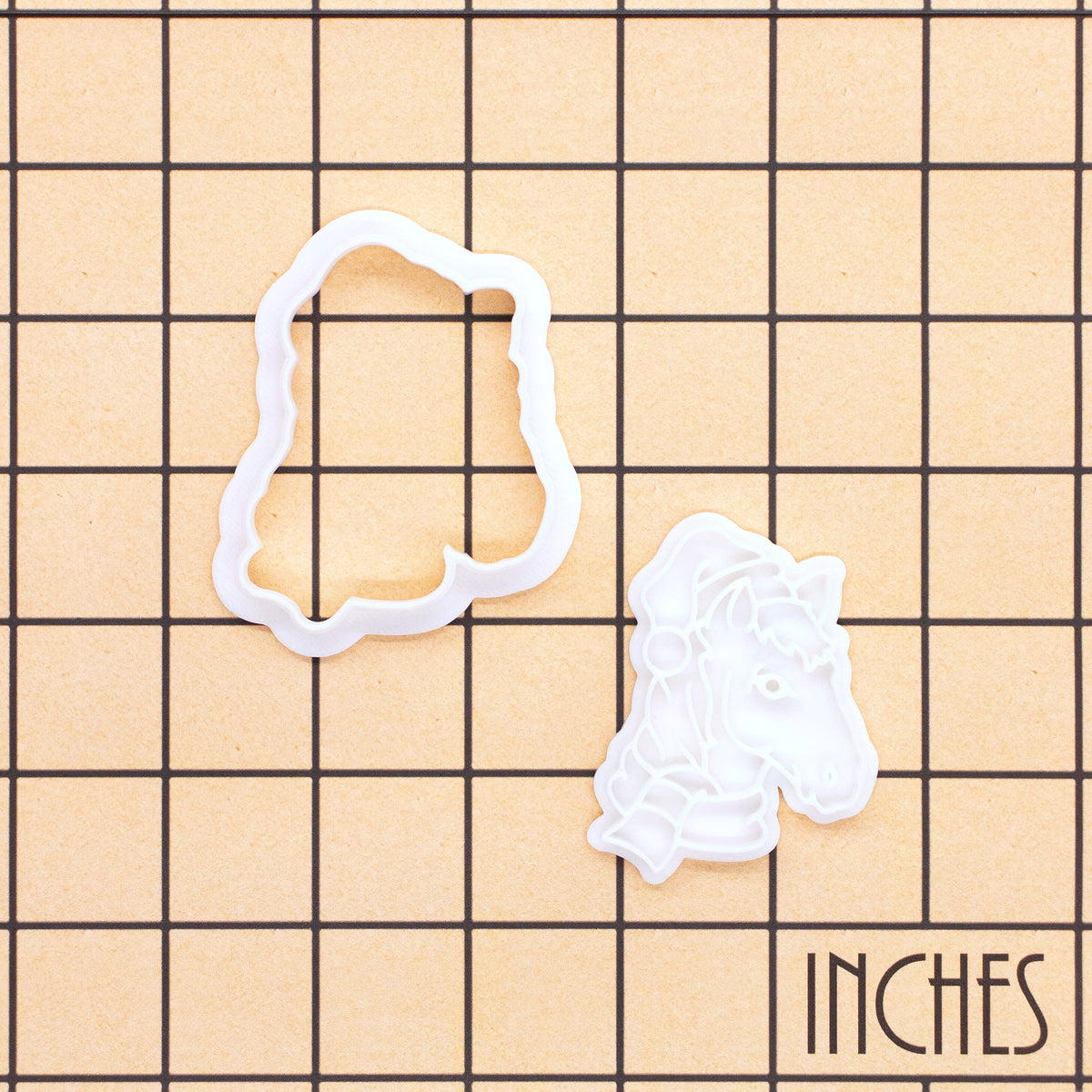 Christmas horse head mini outline cutter and detail stamp shown on inch measurement grid