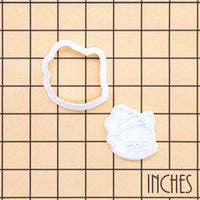 Christmas cat face mini outline cutter and detailed Santa hat stamp on inch measurement grid