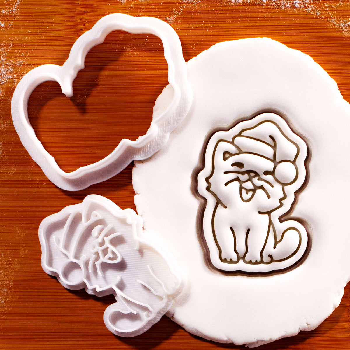 Happy Christmas cat mini cookie cutter and stamp with Santa hat pressed into fondant