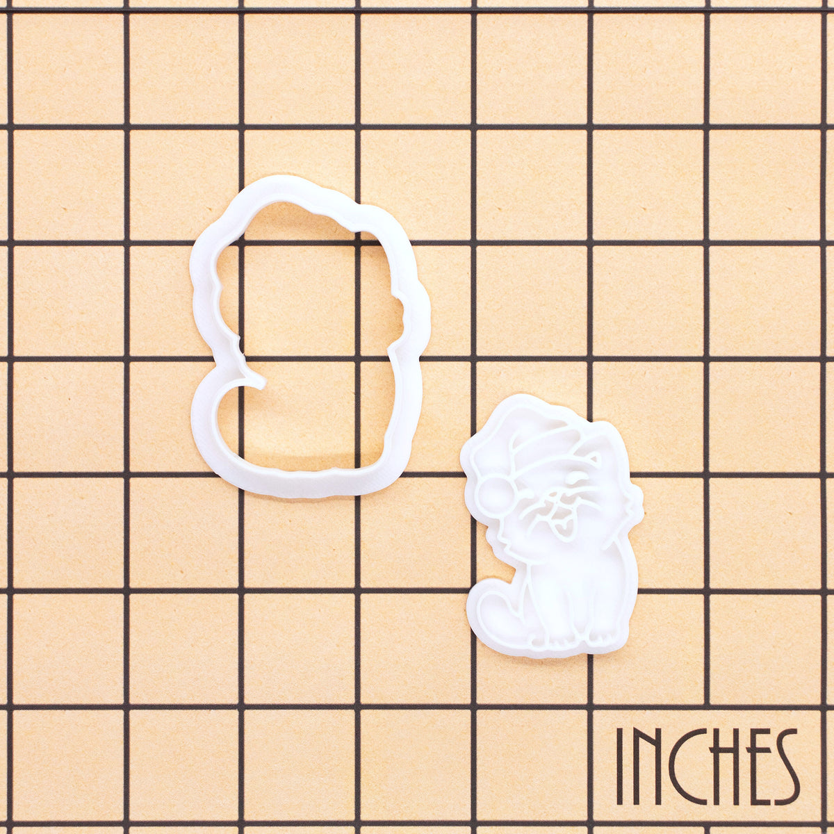 Happy Christmas cat mini outline cutter and detailed Santa hat stamp on inch measurement grid