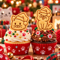 Two Christmas cat biscuit toppers on festive cupcakes, featuring a cat face and happy cat with Santa hats