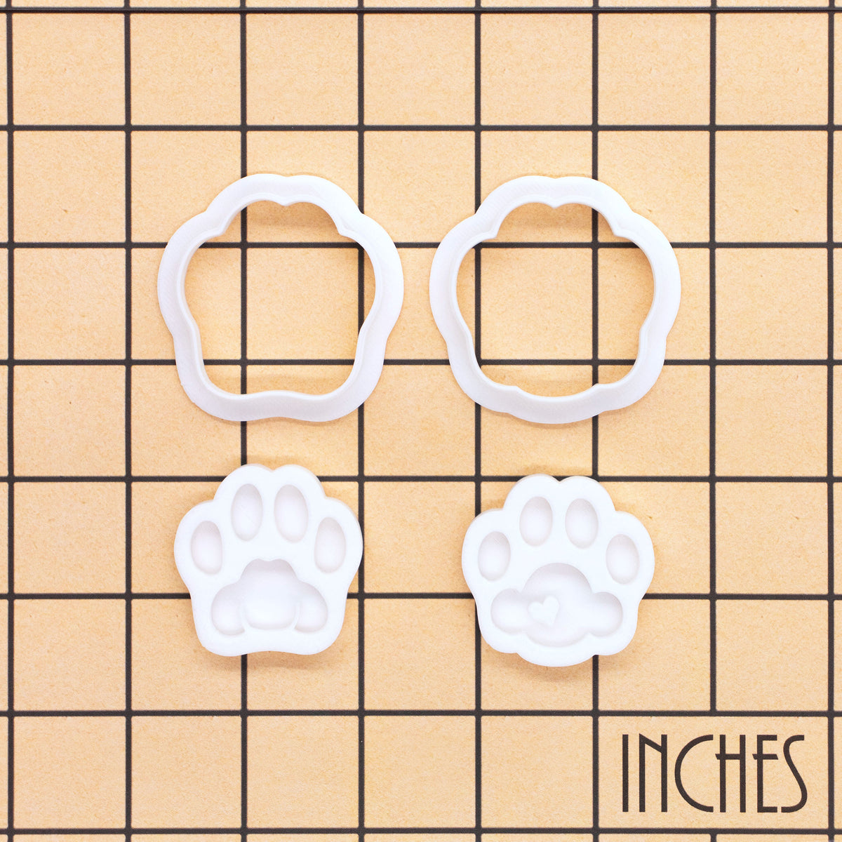 Set of 2 kitty paw mini cookie cutters and stamps in cute and realistic designs shown on inch measurement grid