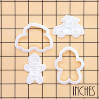 Christmas tree car and gingerbread man mini cookie cutter and stamp set shown on inch measurement grid