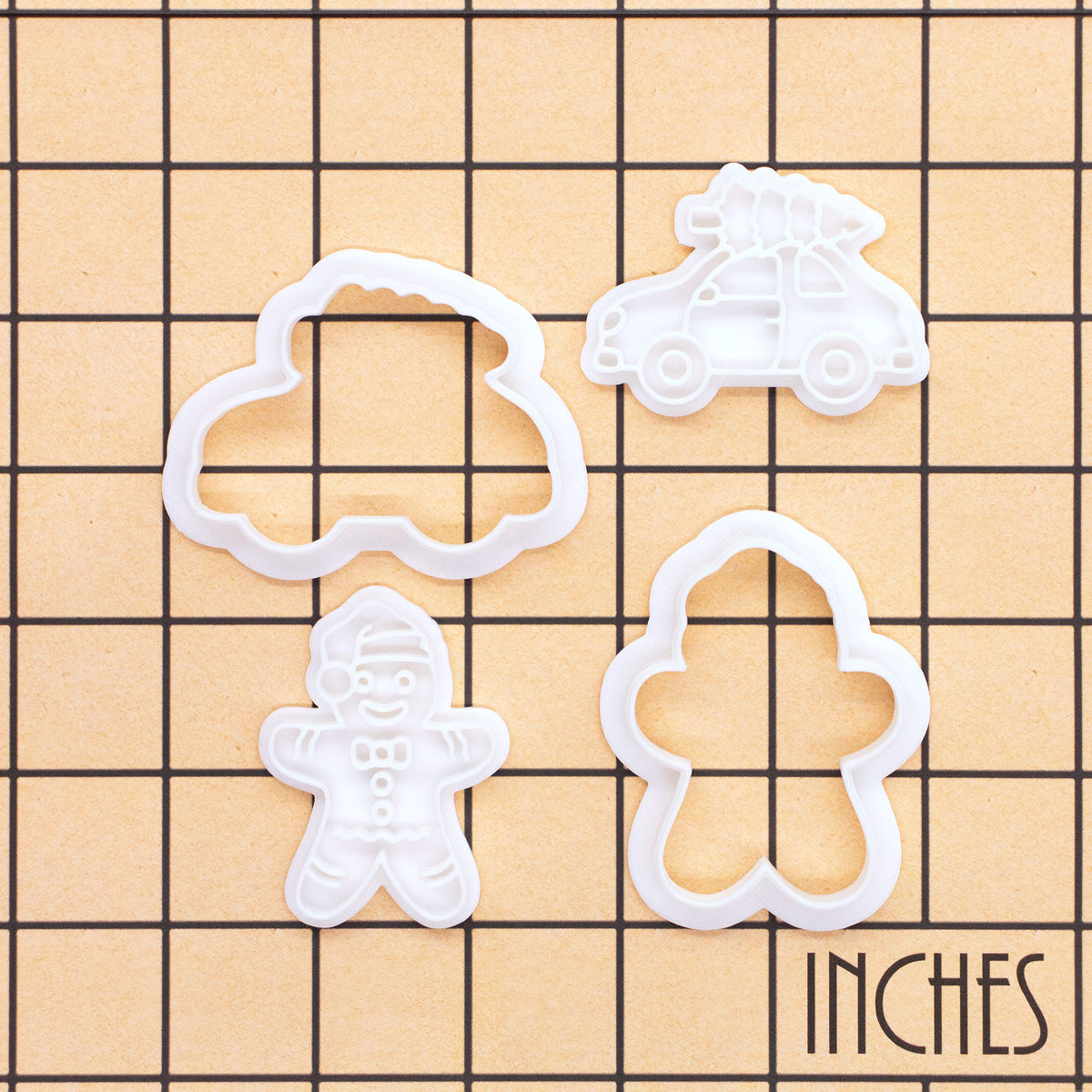 Christmas tree car and gingerbread man mini cookie cutter and stamp set shown on inch measurement grid