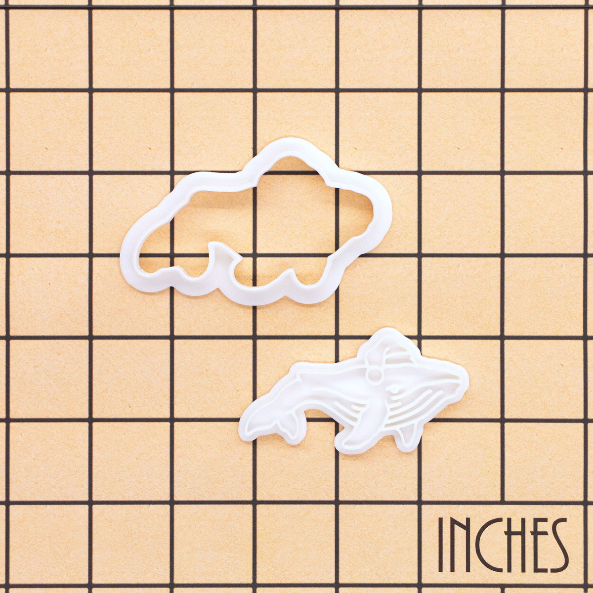 Christmas humpback whale mini cookie cutter and detail stamp on an inch size grid