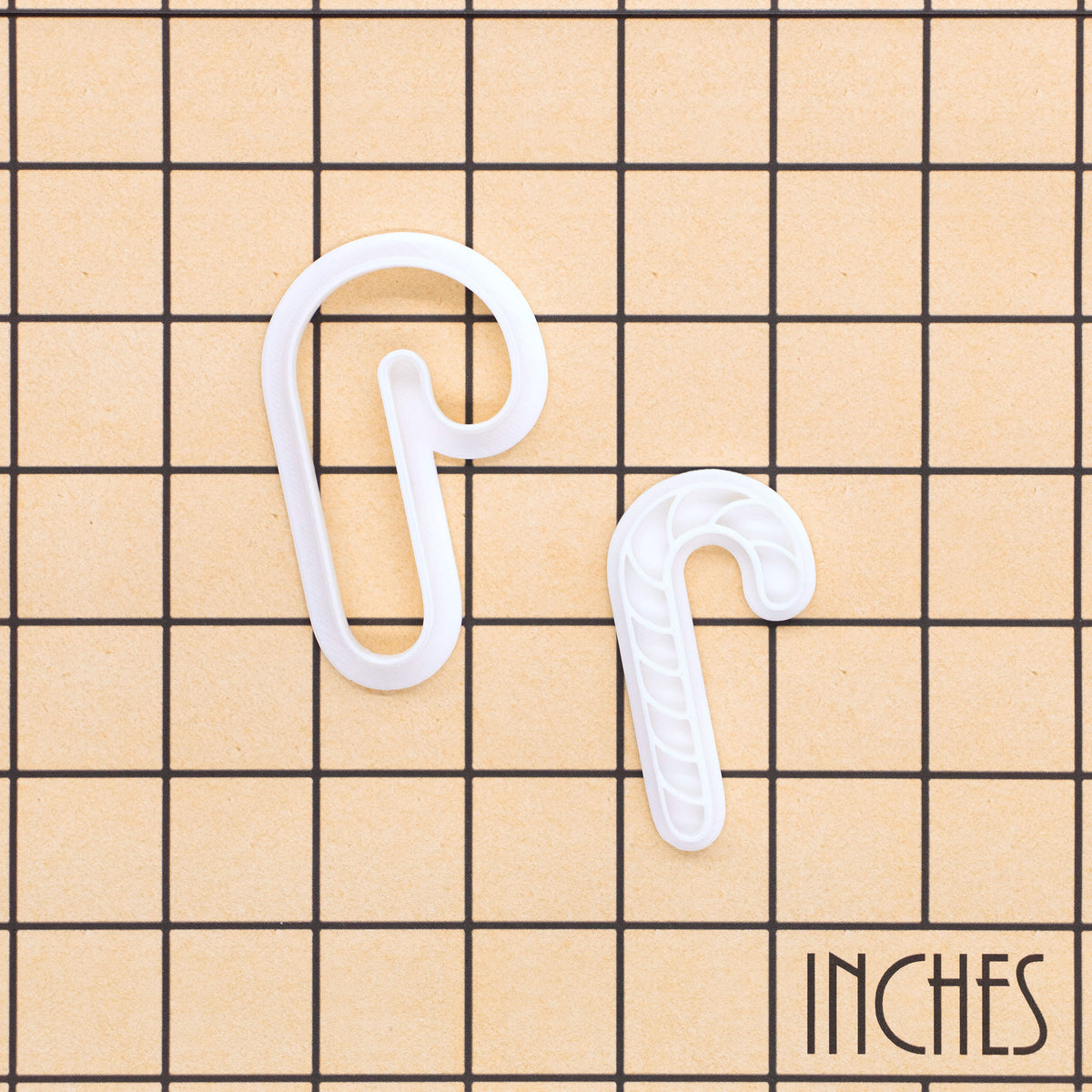 Christmas candy cane mini cookie cutter and stamp shown on inch measurement grid