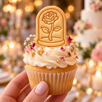Stamped glass dome with rose biscuit used as an elegant floral cupcake topper