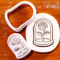 Glass dome with rose mini cookie cutter and stamp beside embossed rose cloche sugarpaste impression