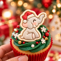 Cute grey baby elephant with Santa hat fondant topper on Christmas cupcake