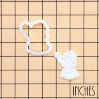 Mini Christmas baby elephant cookie cutter and detailed stamp shown on inch measurement grid