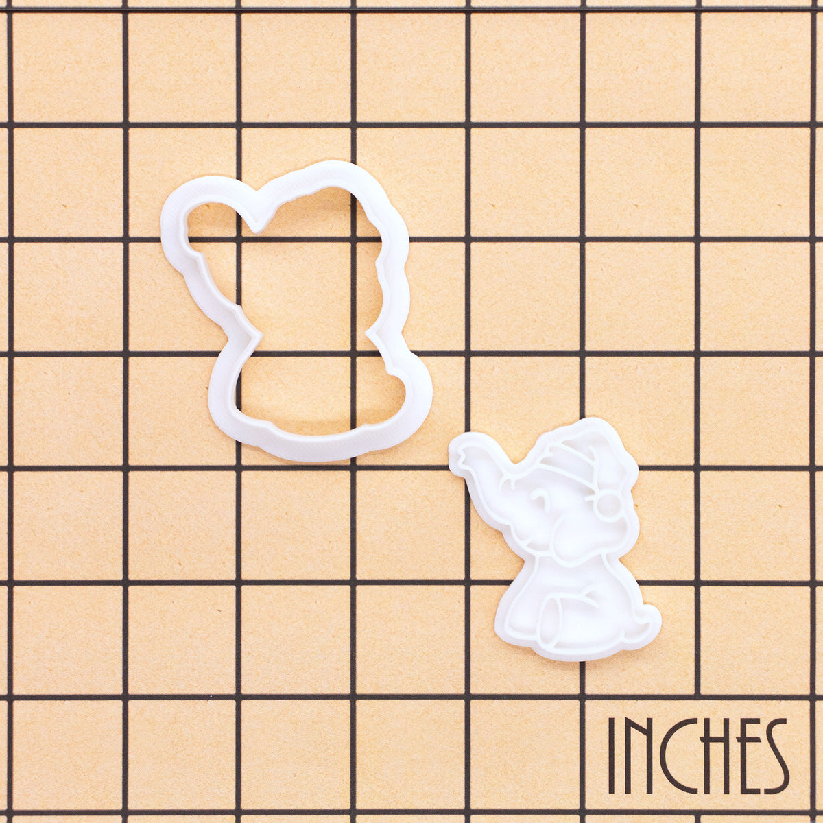 Mini Christmas baby elephant cookie cutter and detailed stamp shown on inch measurement grid