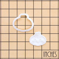 Mini dumpling cookie cutter and smiling Xiao Long Bao stamp shown on inch measurement grid