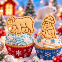 Christmas polar bear and baby penguin stamped biscuit cupcake toppers for festive winter and Arctic themed baking