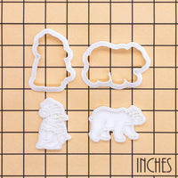 Christmas polar bear and baby penguin mini cookie cutter and stamp set shown on inch measurement grid