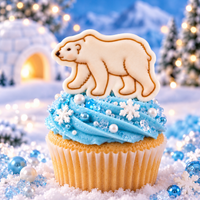 White polar bear fondant cupcake topper with detailed walking bear design in snowy Arctic setting
