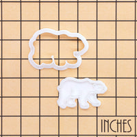 Polar bear mini cookie cutter and stamp set shown on inch measurement grid