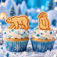 Polar bear and baby penguin stamped biscuit cupcake toppers with blue and white winter decorations