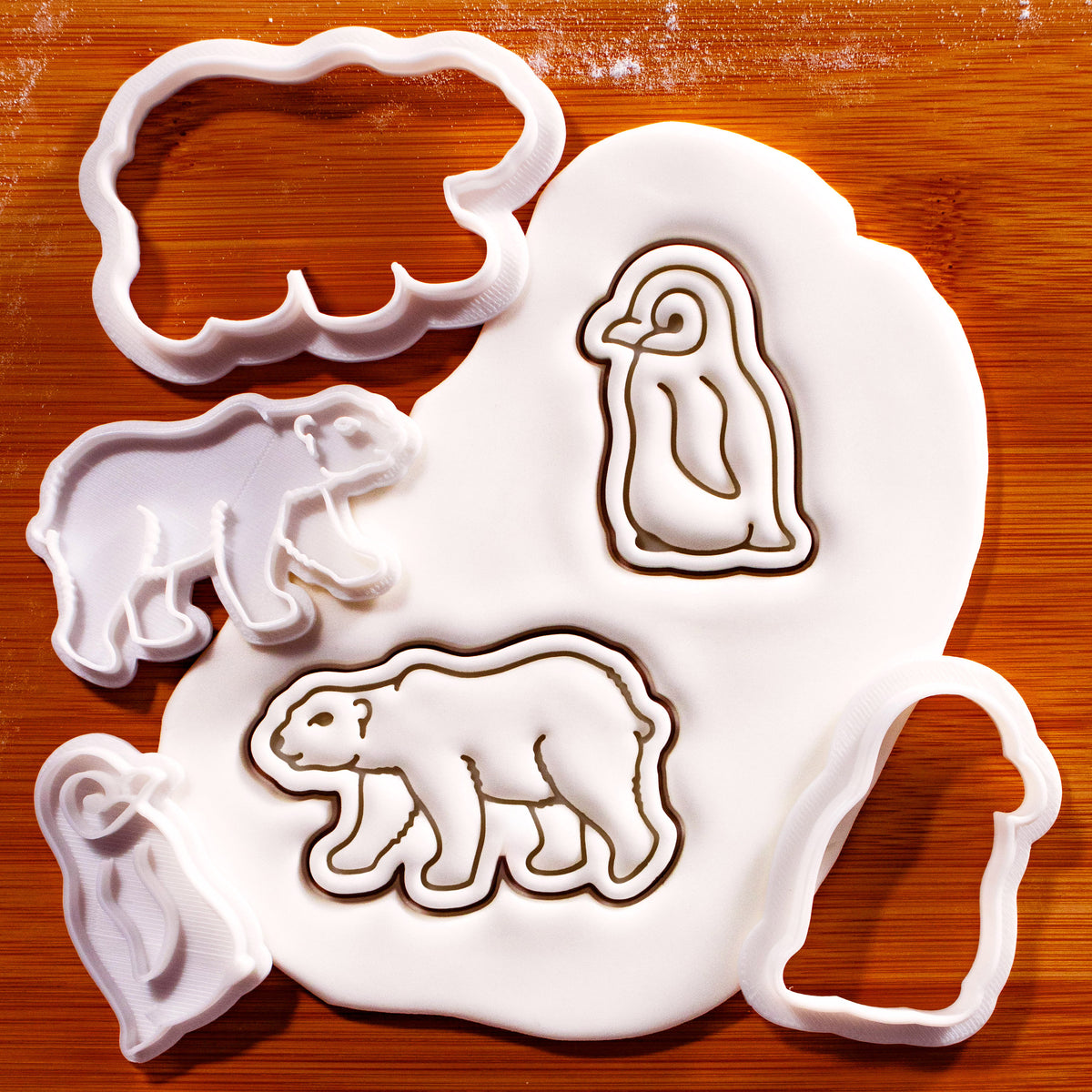 Polar bear and baby penguin mini cookie cutters and stamps with embossed sugarpaste impressions