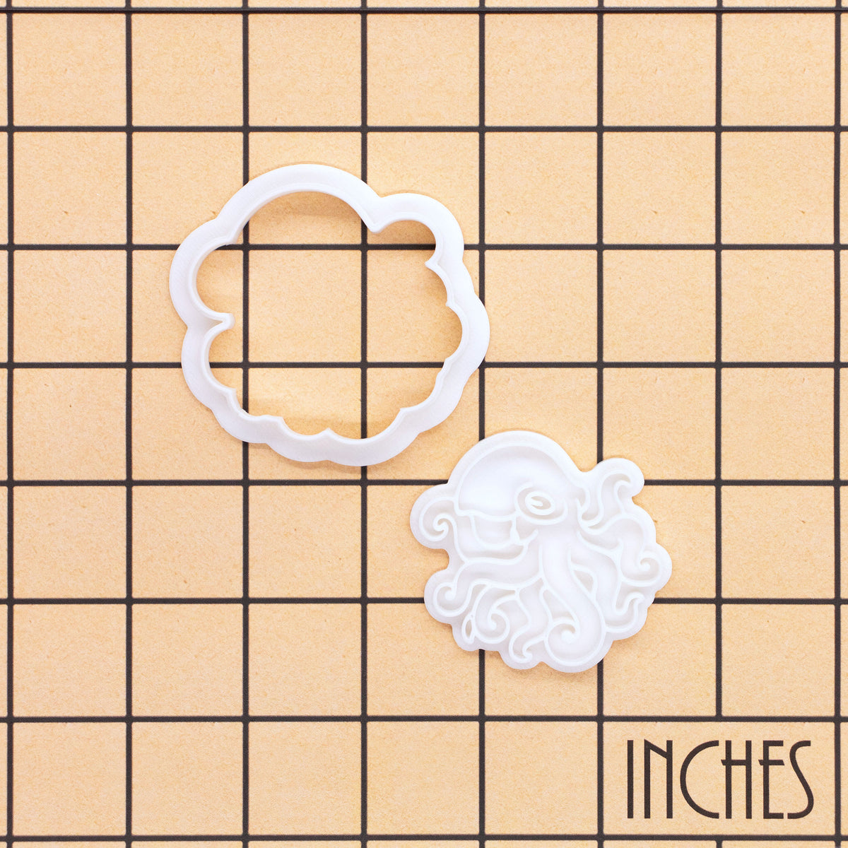 Realistic octopus mini cookie cutter and stamp shown on inch measurement grid
