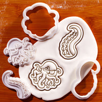 Realistic octopus and tentacles mini cookie cutters and detailed stamps beside embossed sugarpaste impressions