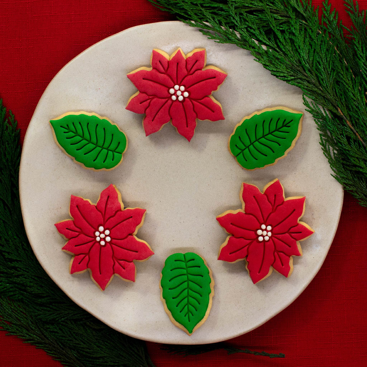 Poinsettia flower and leaves cookies with fondant laid on top
