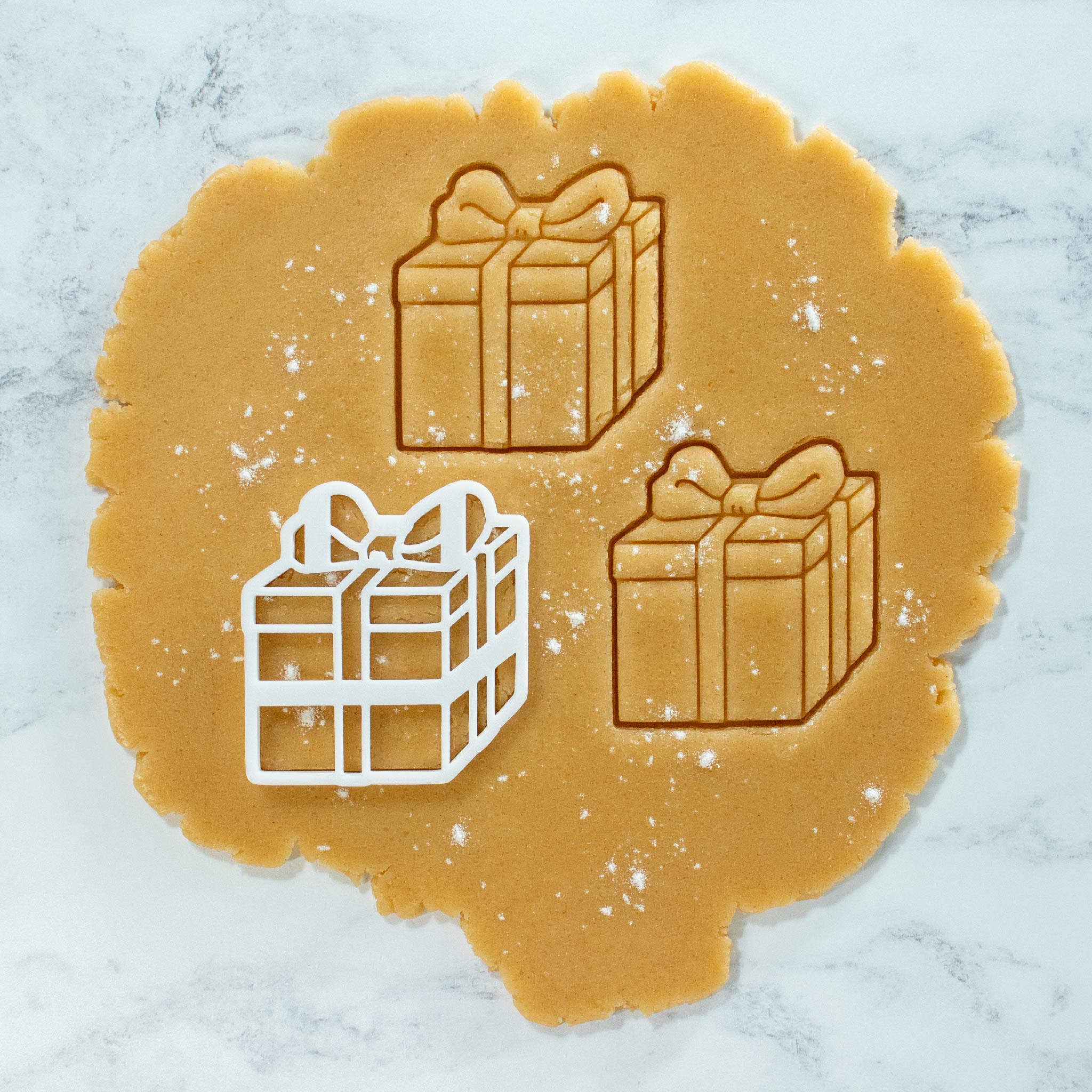 present gift box with bow tie cookies cutout dough made with bakerlogy cookie cutter