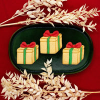 present gift box with bow tie cookies made with bakerlogy cookie cutter
