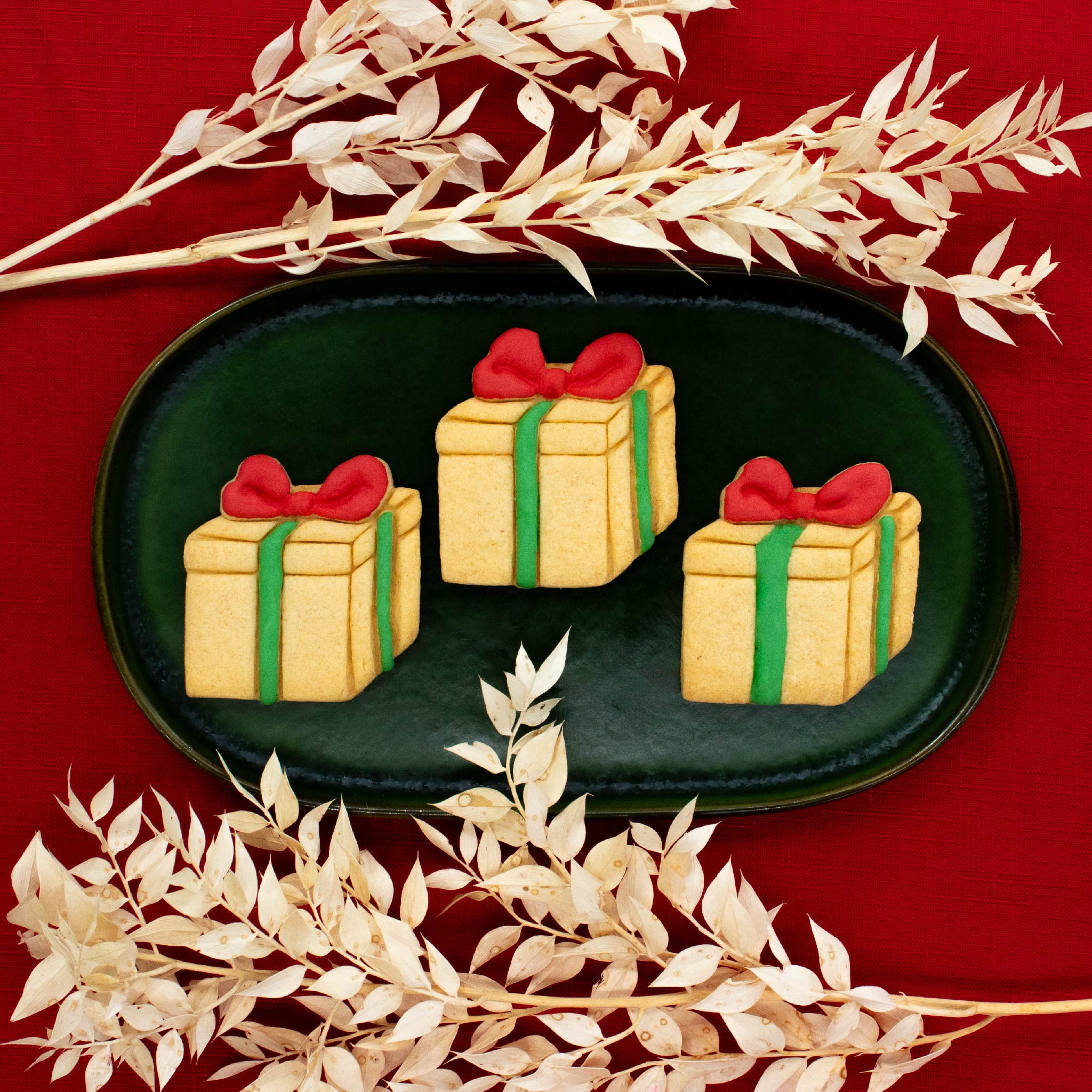 present gift box with bow tie cookies made with bakerlogy cookie cutter