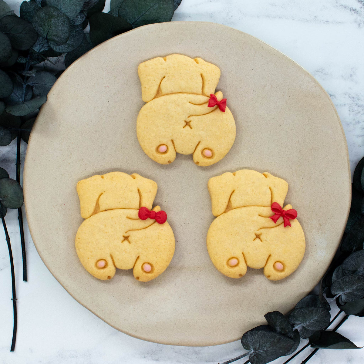 Bakerlogy relaxed dachshund butt sugar cookies decorated with fondant bow ties