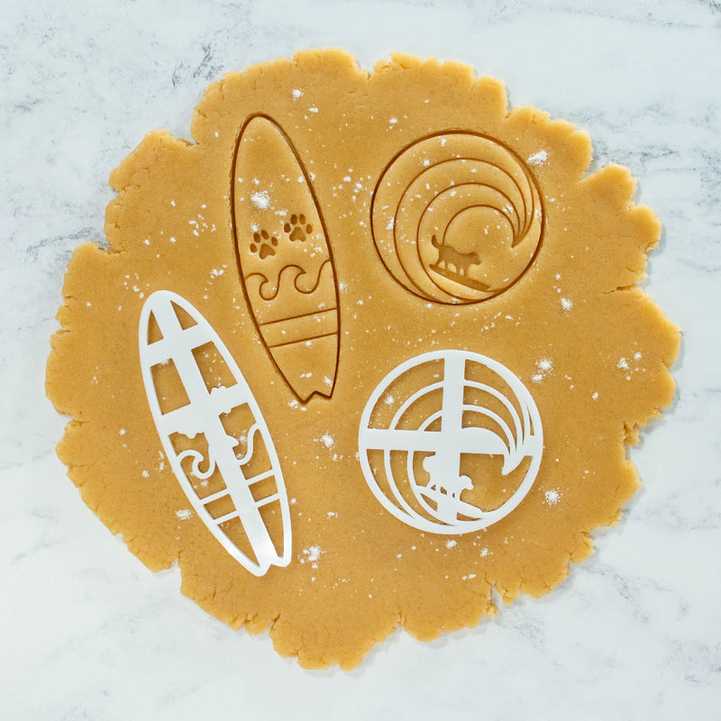 surfer dog and surfboard with paw prints cookie cutout dough made with bakerlogy cookie cutters