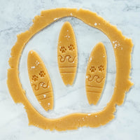 bakerlogy surfboard with paw prints cookies cutout dough