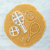 bakerlogy tennis racket and ball sugar cookie cutter and the dough cut outs