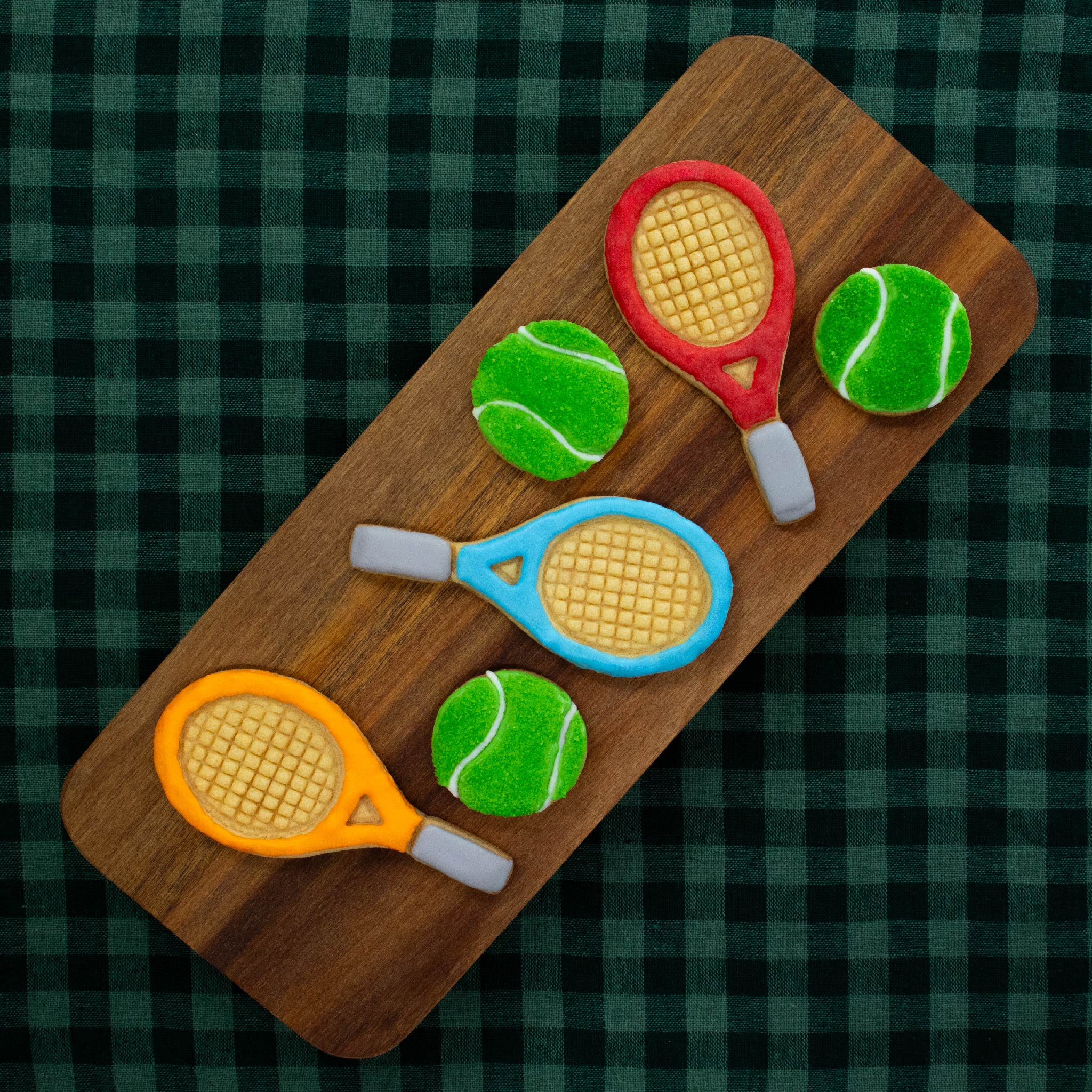 bakerlogy tennis racket and ball sugar cookies colored with royal icing and green granulated sugar