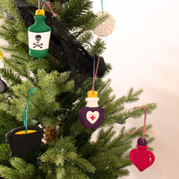 set of 3 toxic bottle, love potion, and health potion clay ornaments on christmas tree