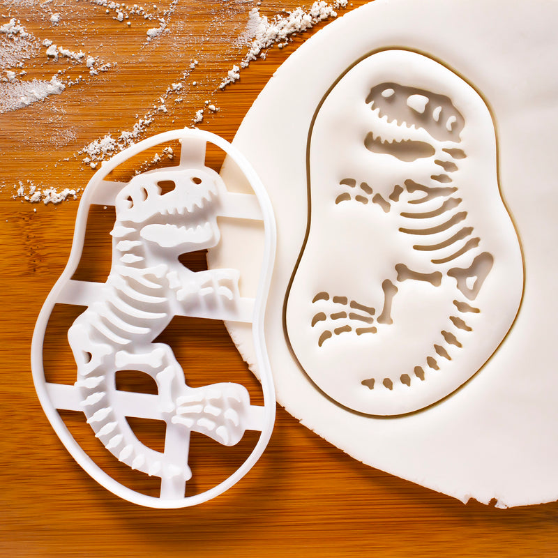 t-rex dinosaur fossil cookie cutter pressed on white fondant