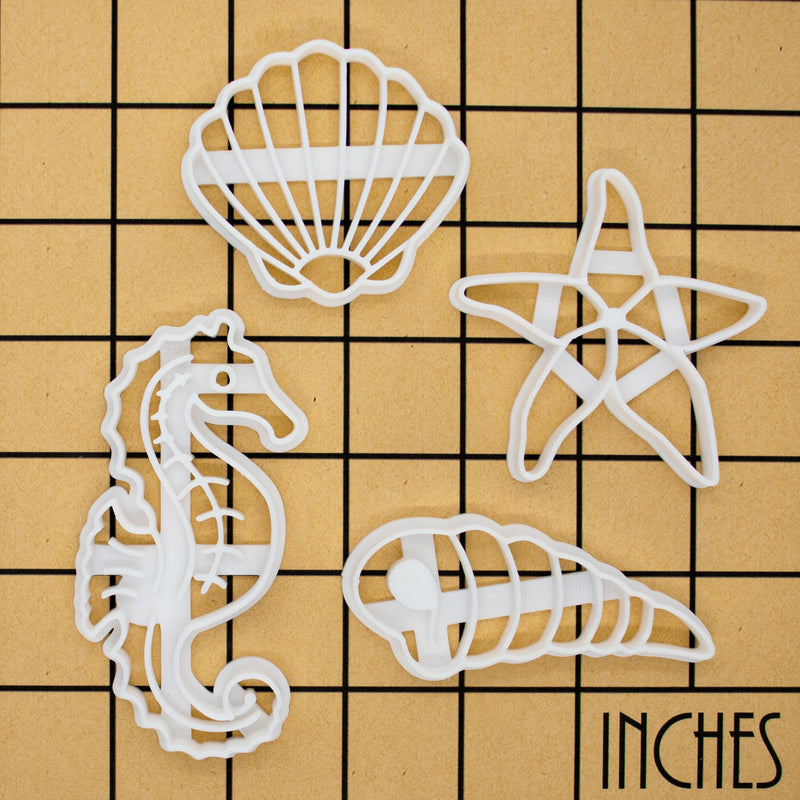 set of 4 cookie cutters, featuring a seashell, a seahorse, a corkscrew and a starfish