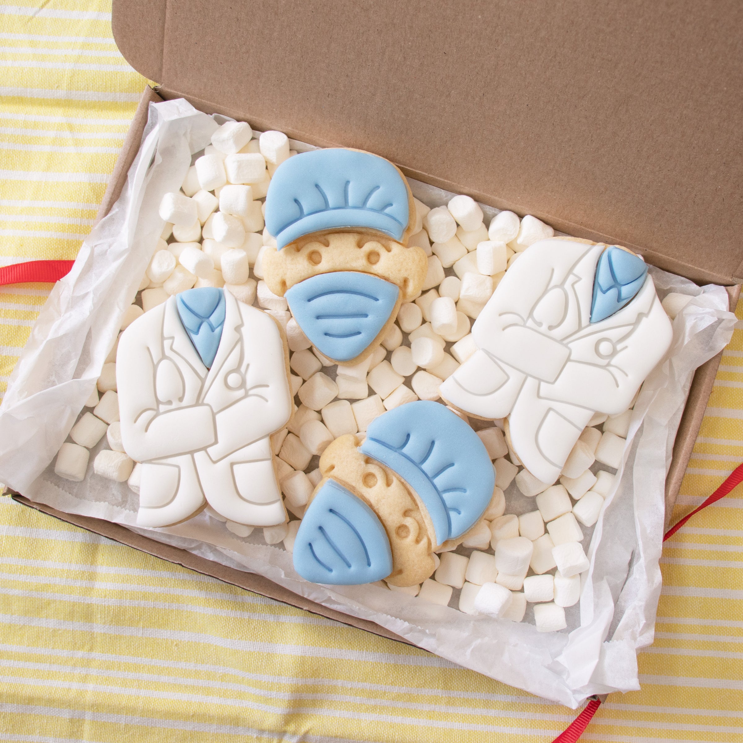 doctor themed cookies, includes leg cast, surgeon face with mask and doctor's coat.